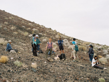 Students take a rest on the steep face of a volcanic crater. Film image by Harry Tang.
