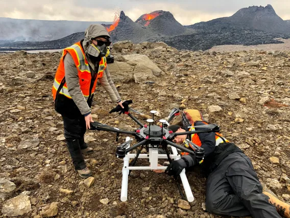 Two researchers attending to a drone.