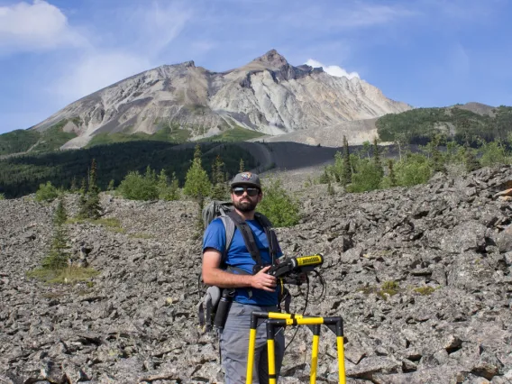 Lead author and graduate student Tyler Meng standing with radar equipment on the Sourdough rock glacier in Alaska in August 2021.