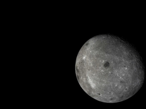The far side of the moon, with distant Earth in the background, is visible in this photo taken by the moon-orbiting module of the Chang'e 5-T1 mission.